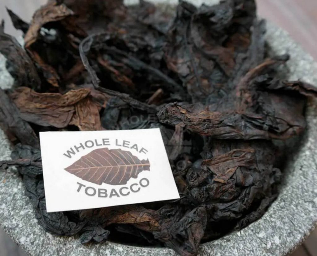 A handful of fire-cured Latakia tobacco, showcasing its unique texture.